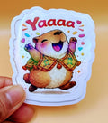 Todo Tumi laminated sticker featuring a joyful capybara in a colorful Peruvian poncho with the text Yaaaaa!