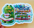 Todo Tumi holographic sticker featuring a green frog holding a coffee cup and book with the quote Black as the devil.