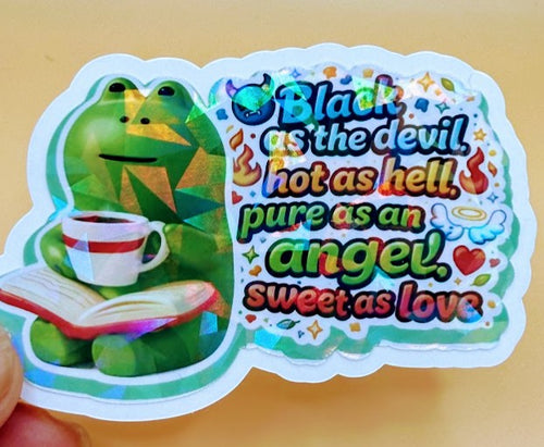 Todo Tumi holographic sticker featuring a green frog holding a coffee cup and book with the quote Black as the devil.