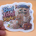Todo Tumi holographic laminated sticker featuring a grumpy crochet cat with a coffee cup and briefcase.