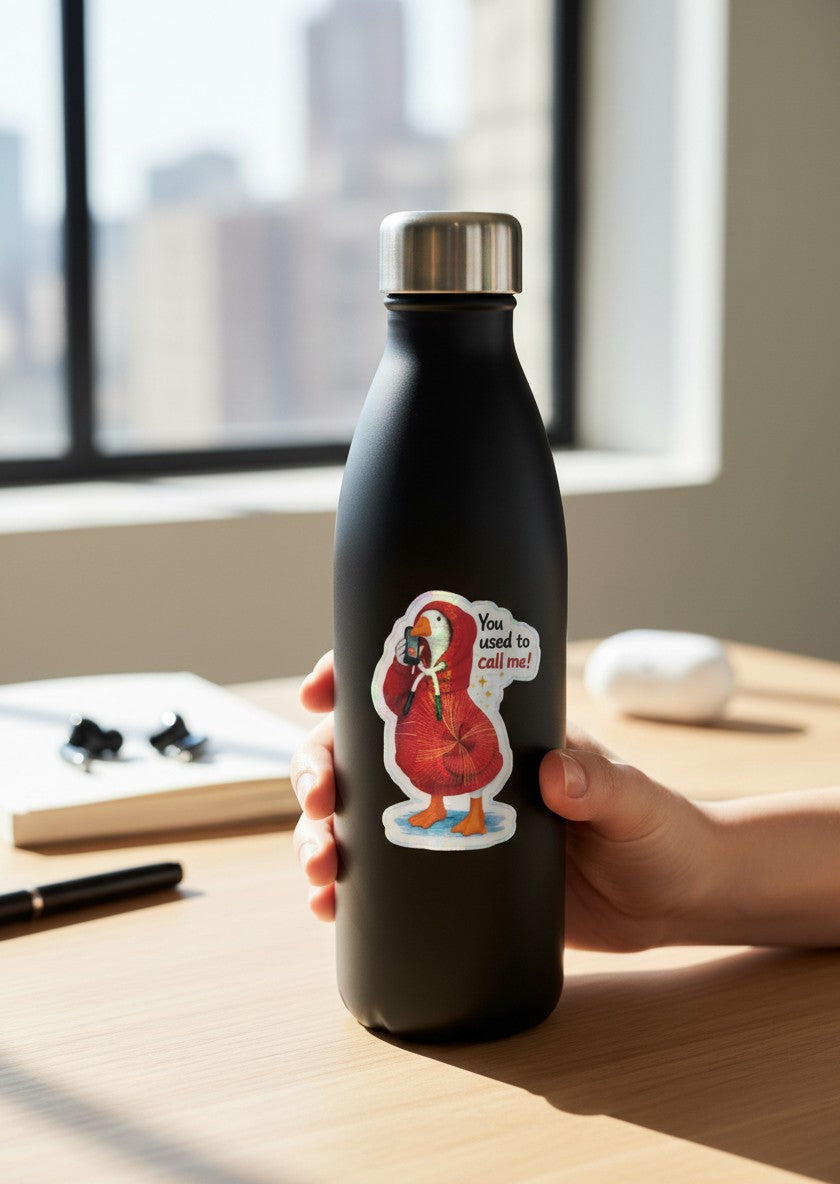 Todo Tumi holographic vinyl sticker of a duck in a red hoodie on a black water bottle, text reads You used to call me