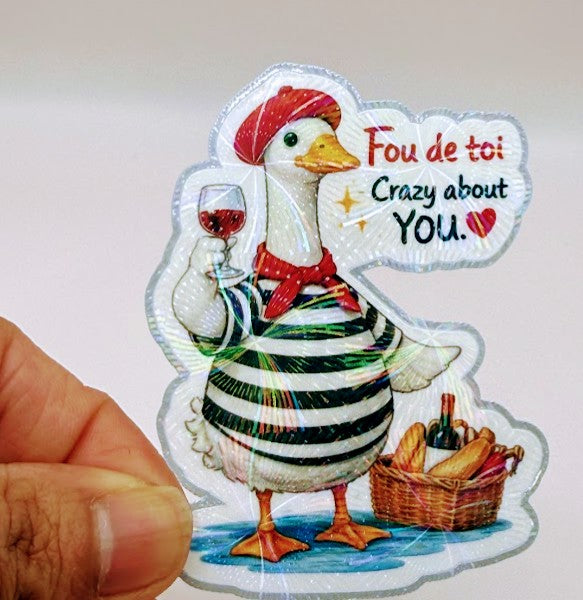 Todo Tumi holographic vinyl sticker featuring a French goose in a striped shirt, red beret, and wine, with bread.