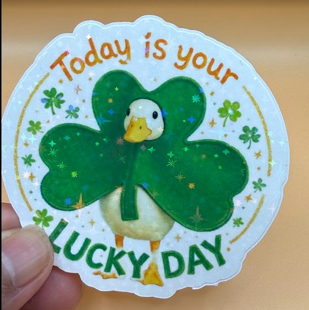 Todo Tumi holographic sticker featuring a cute goose wearing a shamrock with the text Today is your Lucky Day