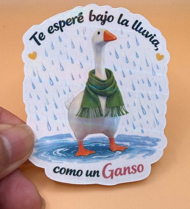 Todo Tumi laminated sticker featuring a white goose in a green scarf standing in the rain with Spanish text.