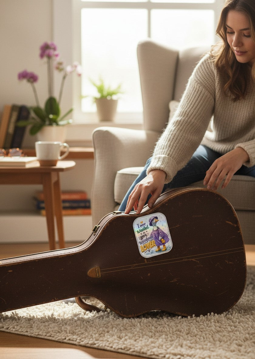 Todo Tumi holographic sticker of a goose in a purple raincoat and yellow boots on a vintage guitar case.
