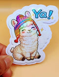 Todo Tumi Ya! llama sticker featuring a cute llama in a colorful chullo hat with a holographic finish.